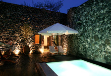 Stone house villas in santorini Stone house hotel pool at night